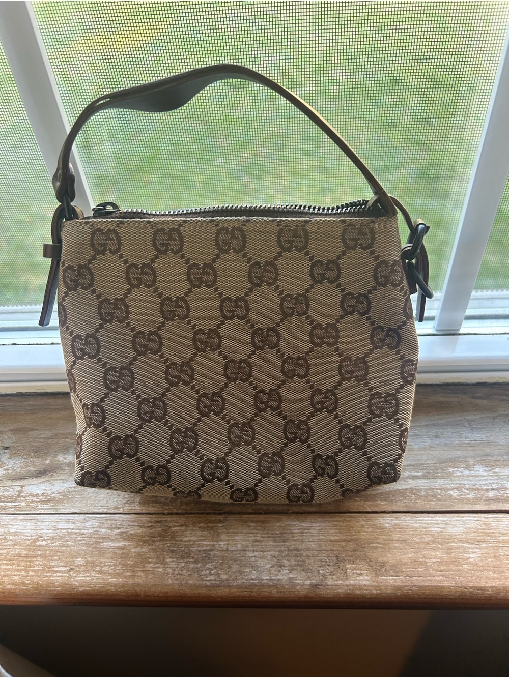 Gucci Beige and Brown Monogram small wrist bag.